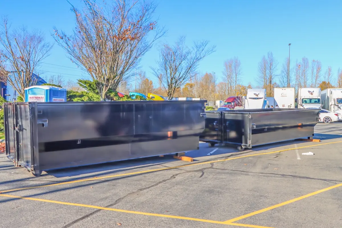 Professional dumpster rental service with roll-off container on residential driveway in Stow